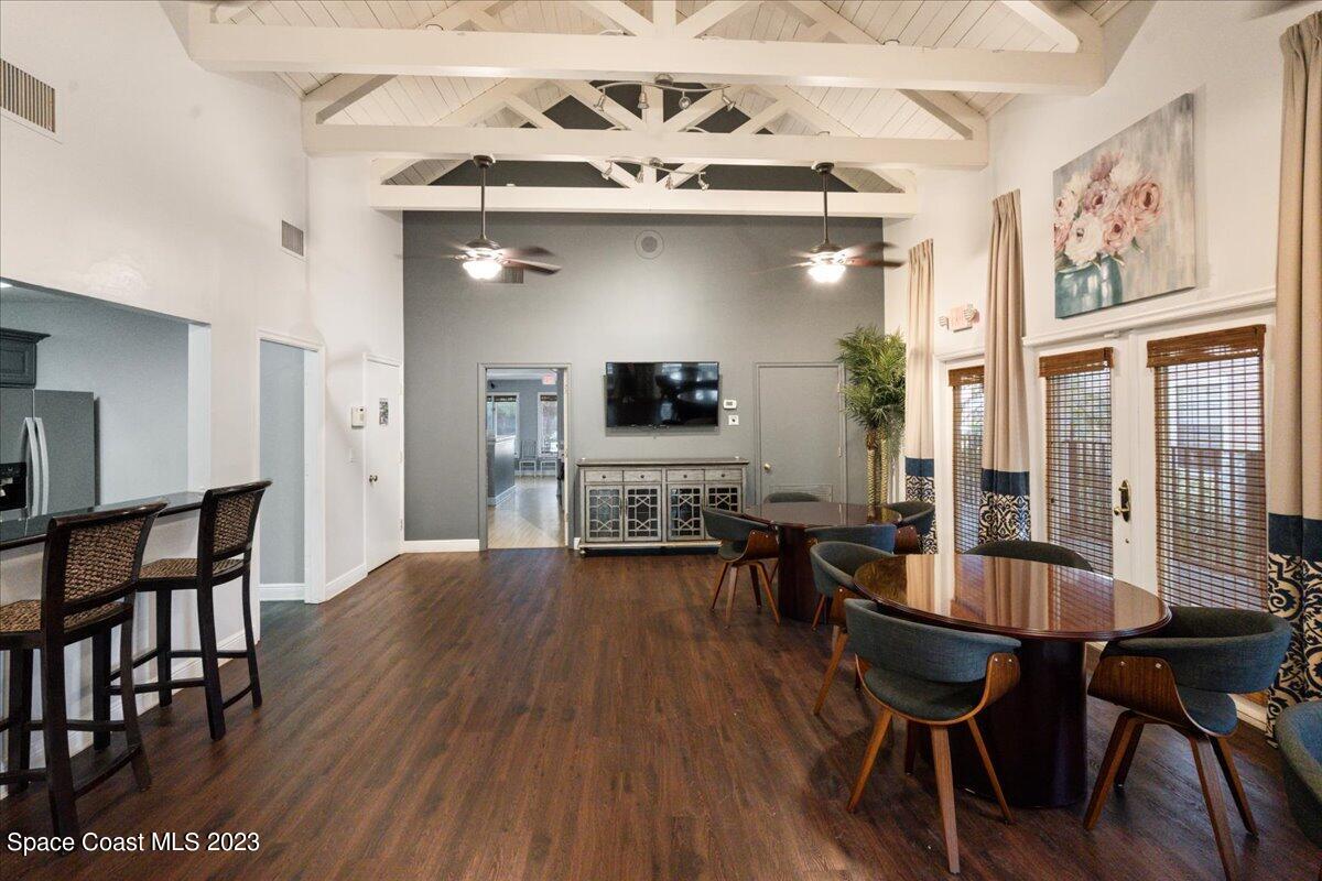 7667 North Wickham Road, Unit 916 Melbourne, FL 32940 - Photo 45 of 53 a view of a dining room with furniture and wooden floor
