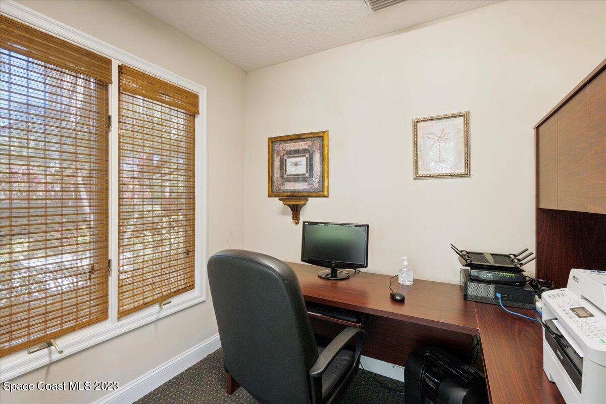 7667 North Wickham Road, Unit 916 Melbourne, FL 32940 - Photo 50 of 53 a view of a workspace with furniture and a window