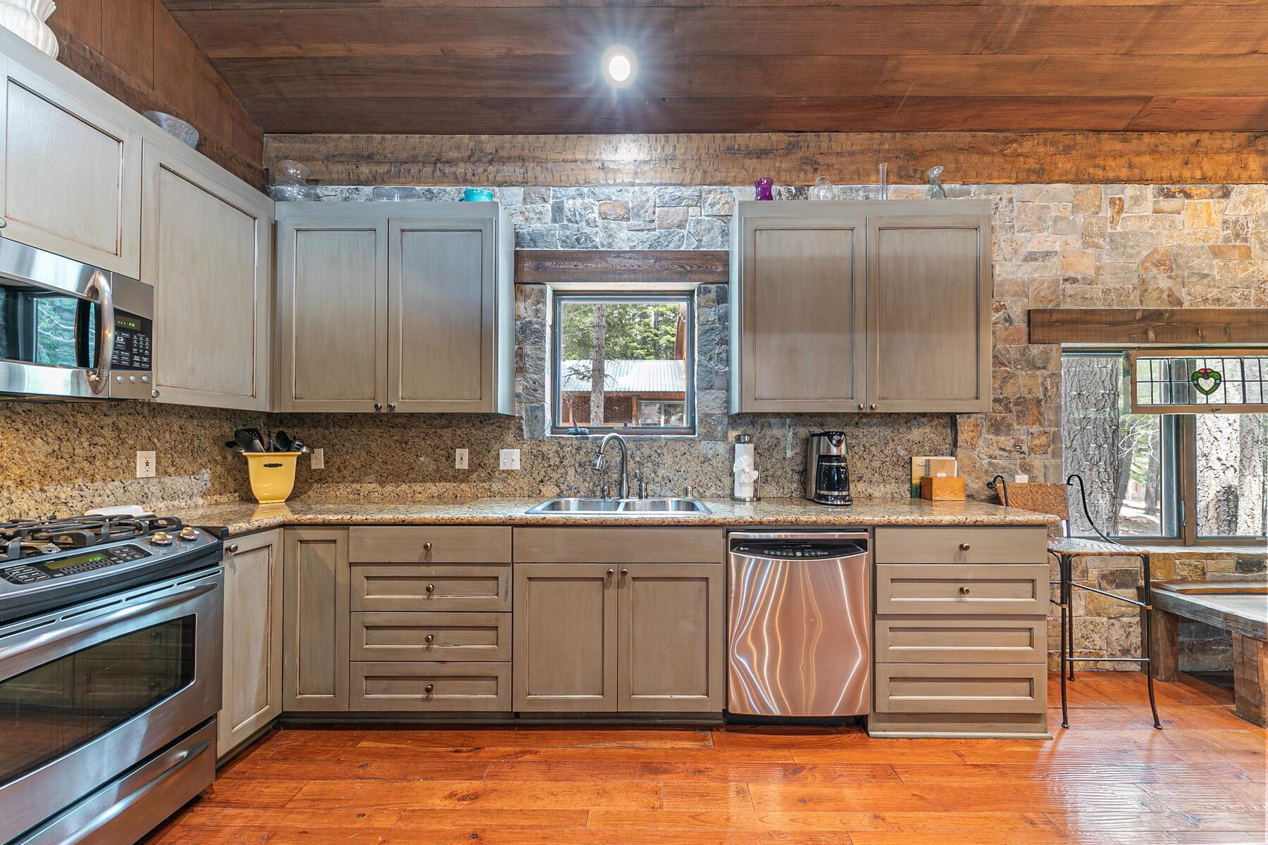 12209 Greenleaf Way Truckee, CA 96161 - Photo 13 of 28 a kitchen with stainless steel appliances granite countertop a stove a sink and a microwave