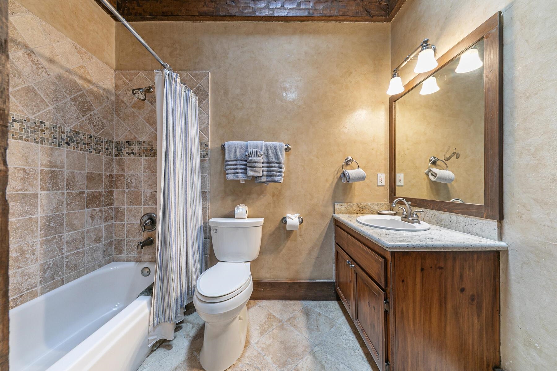 12209 Greenleaf Way Truckee, CA 96161 - Photo 19 of 28 a bathroom with a sink a toilet and shower