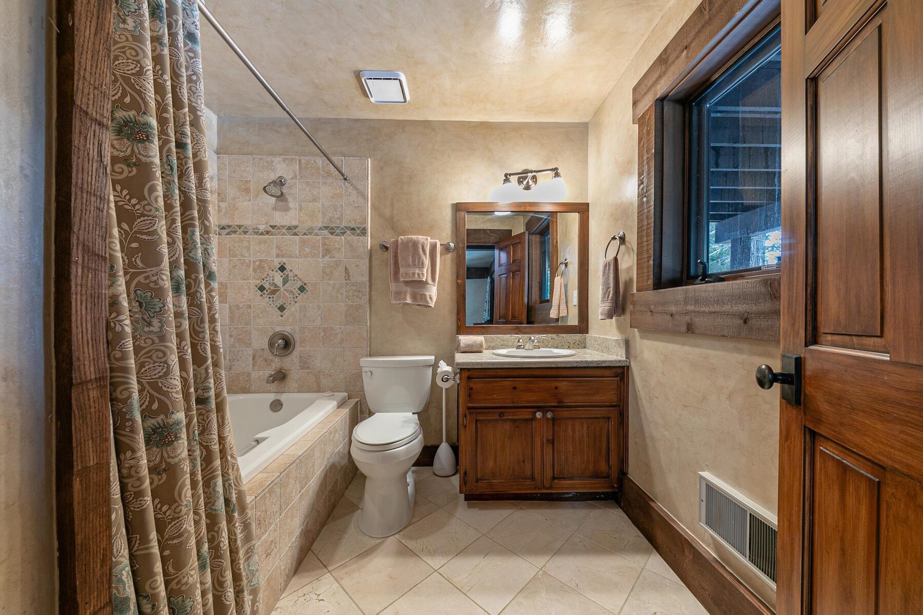 12209 Greenleaf Way Truckee, CA 96161 - Photo 24 of 28 a bathroom with a sink toilet and shower