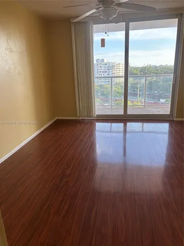 a view of a kitchen with wooden cabinets