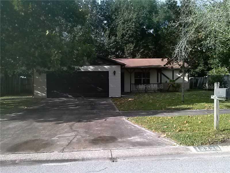 12239 Shadow Ridge Boulevard Hudson, FL 34669 - Photo 1 of 1 front view of a house with a yard