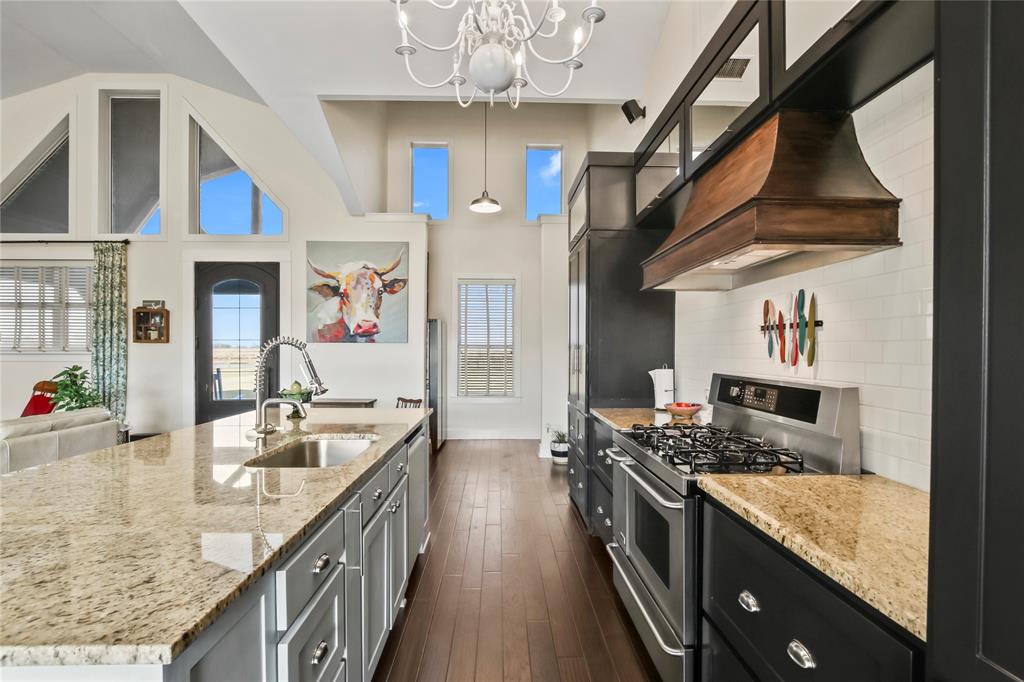 125 George Owens Road Ponder, TX 76259 - Photo 2 of 37 a kitchen with stainless steel appliances granite countertop lots of counter top space