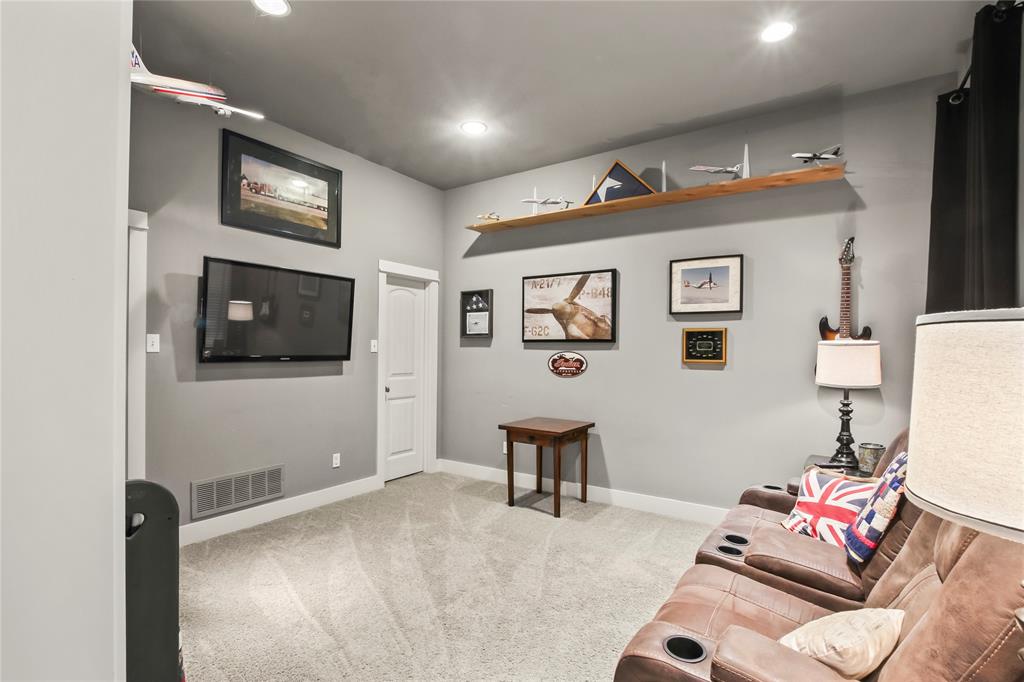 125 George Owens Road Ponder, TX 76259 - Photo 22 of 37 a living room with furniture and a flat screen tv