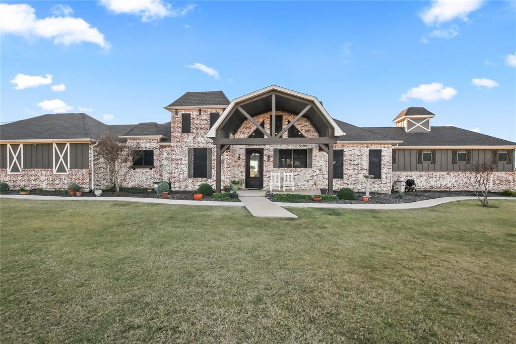 125 George Owens Road Ponder, TX 76259 - Photo 30 of 37 a front view of a house with a yard table and chairs
