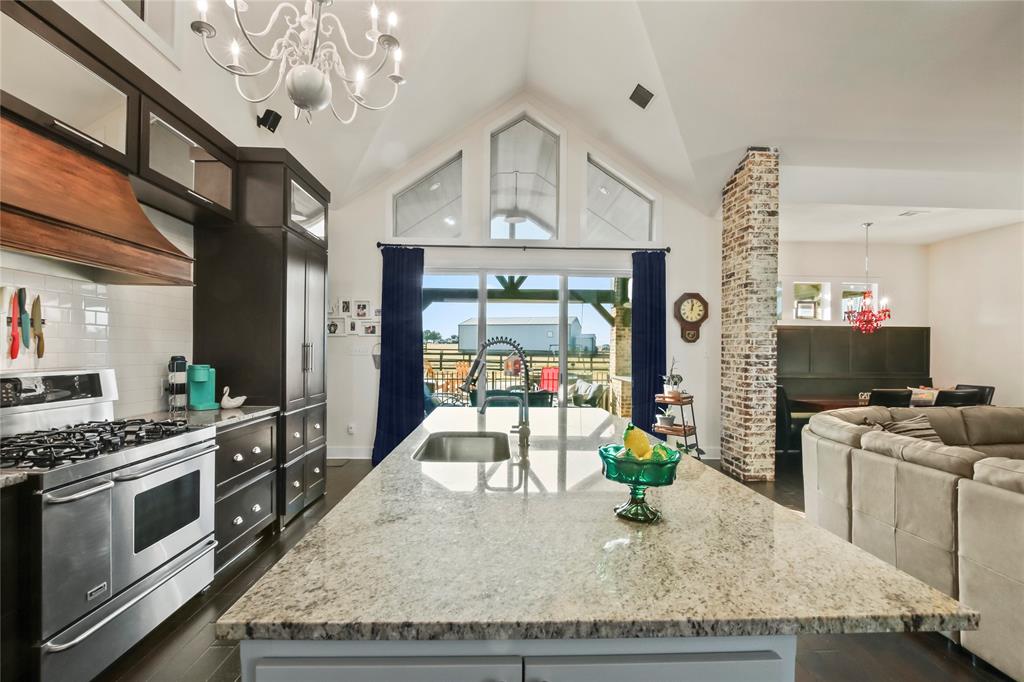 125 George Owens Road Ponder, TX 76259 - Photo 4 of 37 a kitchen with stainless steel appliances granite countertop a sink dishwasher stove and refrigerator with wooden floor