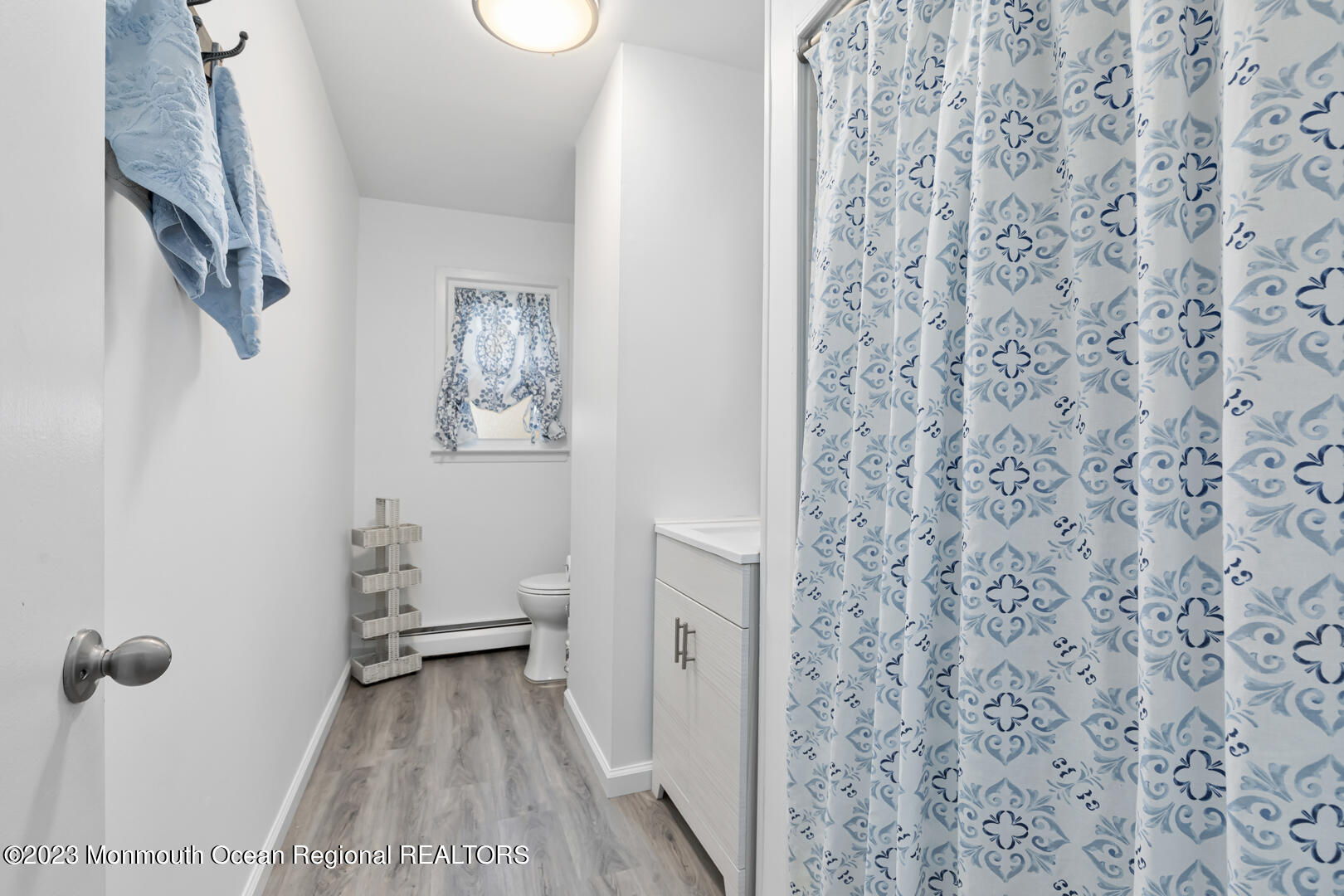 9 Schelly Drive Middletown, NJ 07748 - Photo 19 of 25 a bathroom with a toilet and a shower curtain