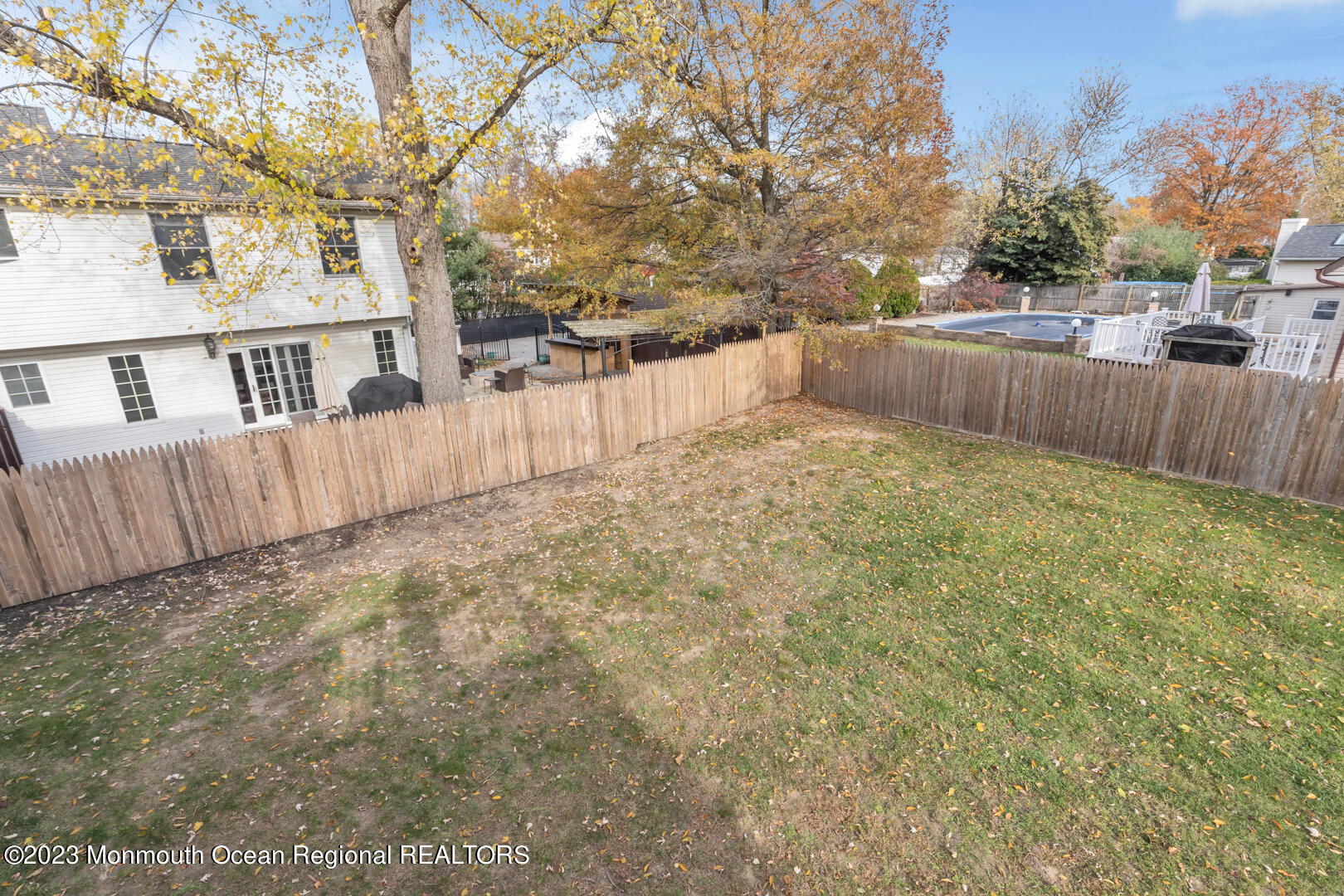9 Schelly Drive Middletown, NJ 07748 - Photo 24 of 25 a view of backyard with large trees and wooden fence