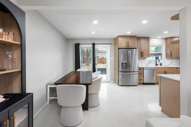 a kitchen with refrigerator and microwave