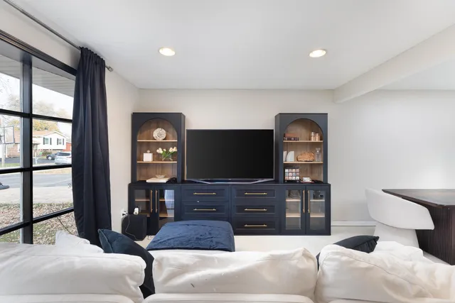 a living room with furniture and a kitchen view