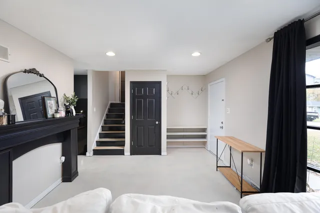 a hallway with stainless steel appliances furniture and kitchen view