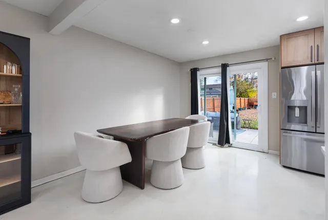 a kitchen with stainless steel appliances granite countertop a refrigerator a stove a sink and a microwave