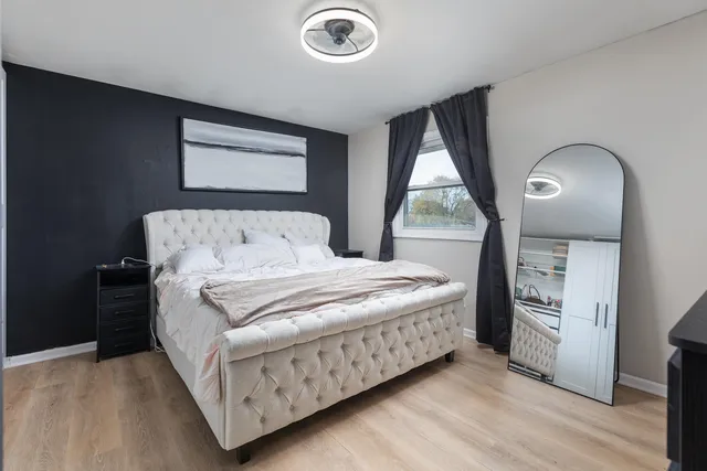 a bedroom with a bed and a window