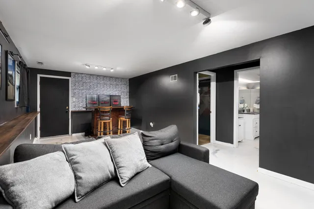 a dining room with furniture and view kitchen