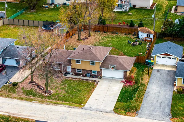 an aerial view of residential house with outdoor space and parking