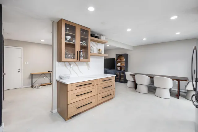 a living room with furniture and a night stand