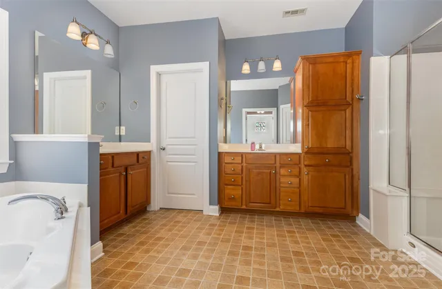 a bathroom with a granite countertop sink a toilet and mirror
