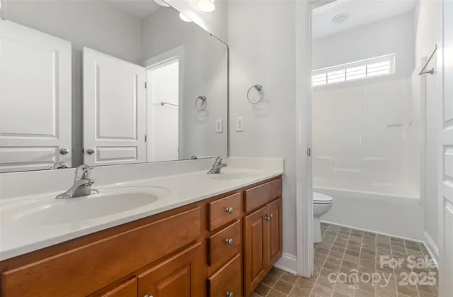 a bedroom with a bed and a table chair