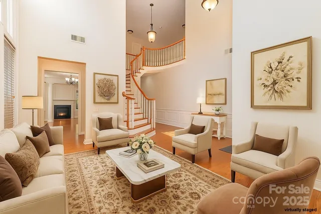 a living room with furniture a rug and a painting