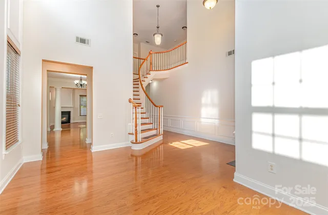 a view of a room with wooden floor and windows