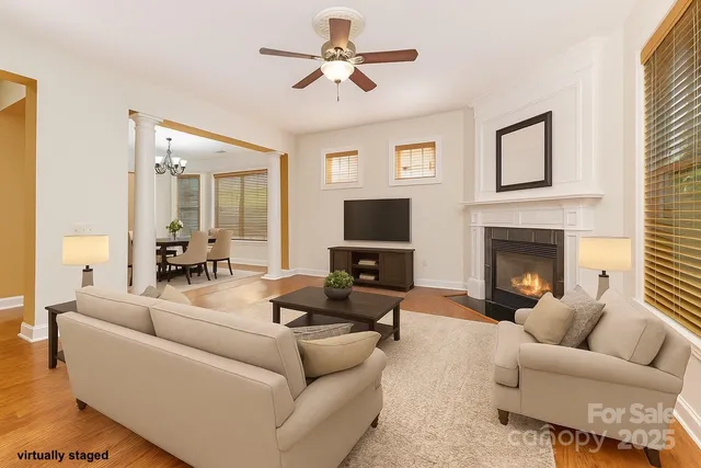 a living room with furniture a fireplace and a flat screen tv