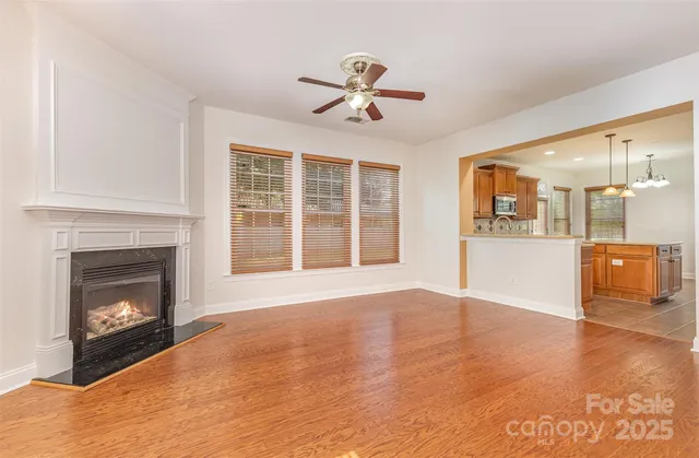 a view of an empty room with a fireplace and a window