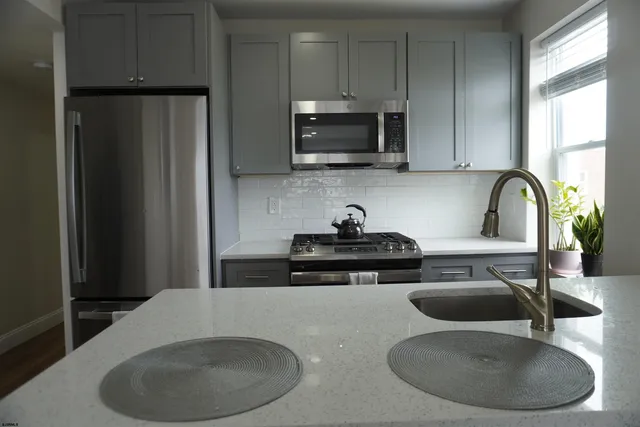 a kitchen with a sink a microwave and refrigerator