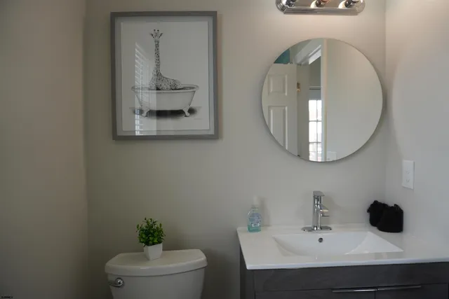 a bathroom with a toilet a sink and mirror