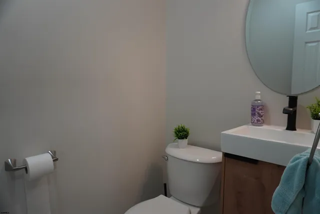 a white toilet sitting next to a bathroom sink