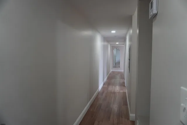 a view of hallway with wooden floor