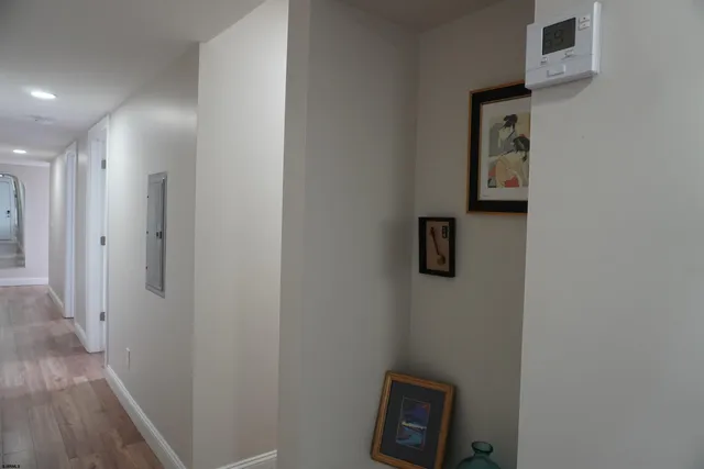 a view of a hallway with wooden floor