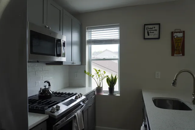 a kitchen with a stove and a bathtub