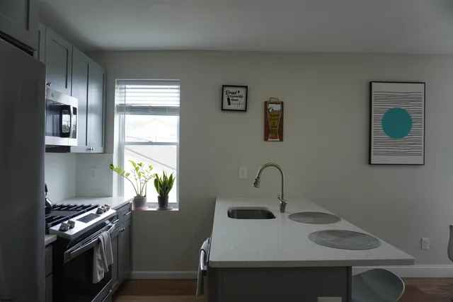 a kitchen with a sink and a stove top oven