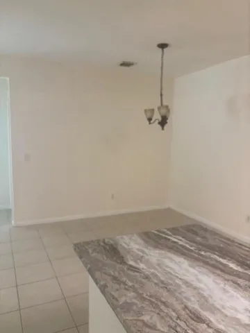 a view of a refrigerator and window in a room