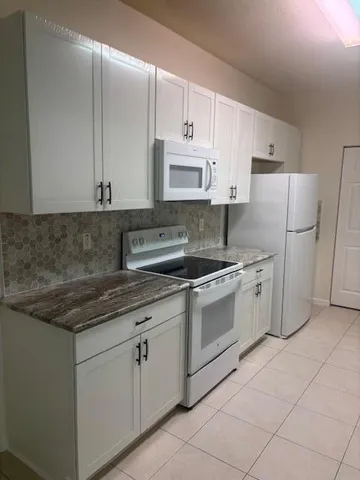 a kitchen with appliances cabinets and a sink
