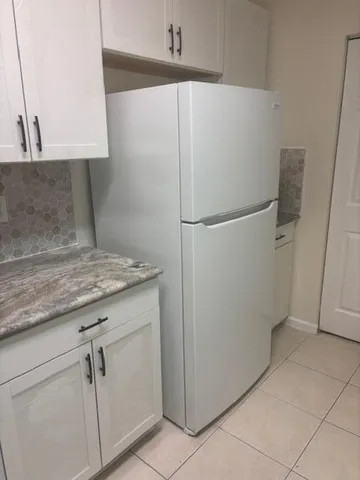 a white refrigerator freezer sitting in a kitchen