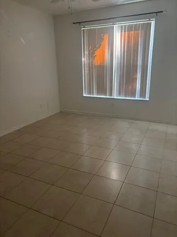 a bathroom with a granite countertop sink a toilet and bathtub
