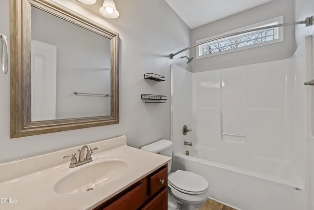 a living room with furniture and a ceiling fan