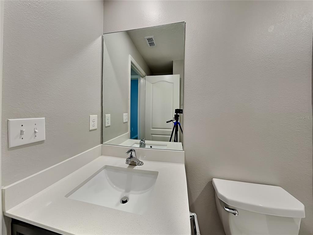 Undisclosed Address Lakeland, FL 33811 - Photo 15 of 17 a bathroom with a sink and mirror with toilet