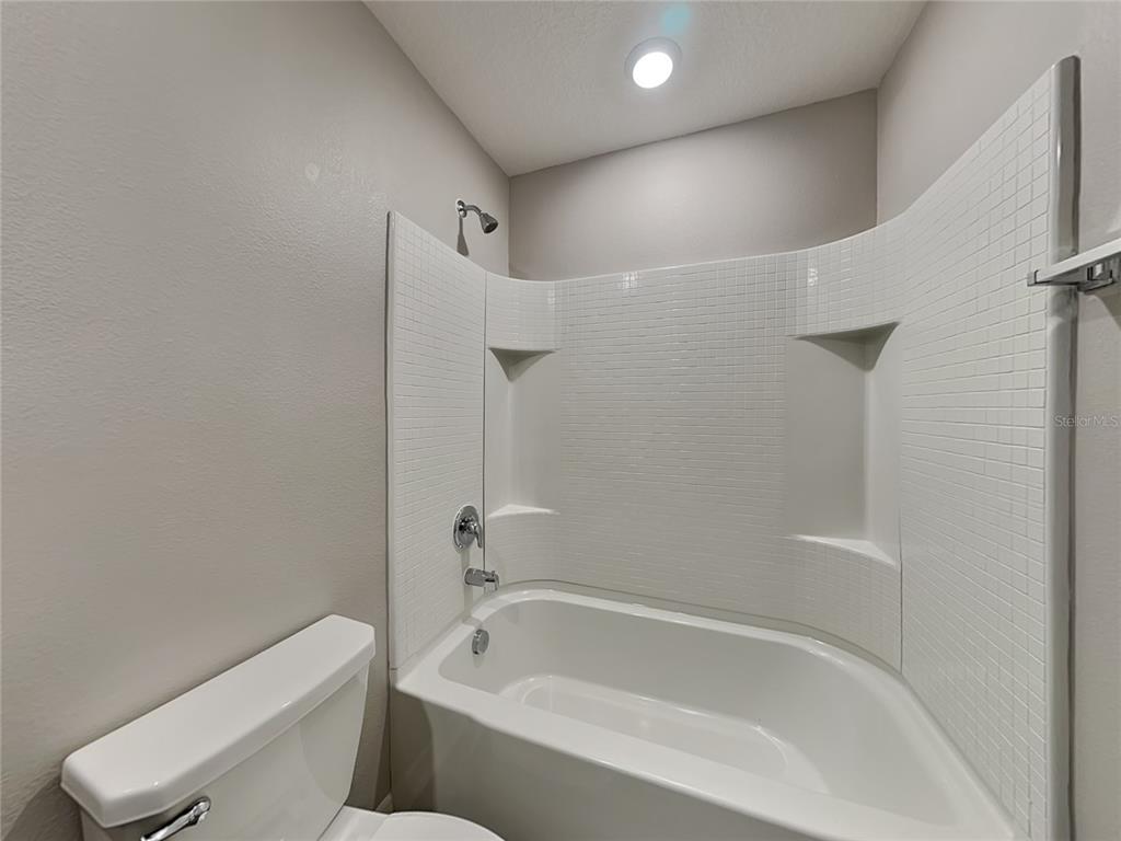 Undisclosed Address Lakeland, FL 33811 - Photo 16 of 17 a white bath tub sitting next to a toilet
