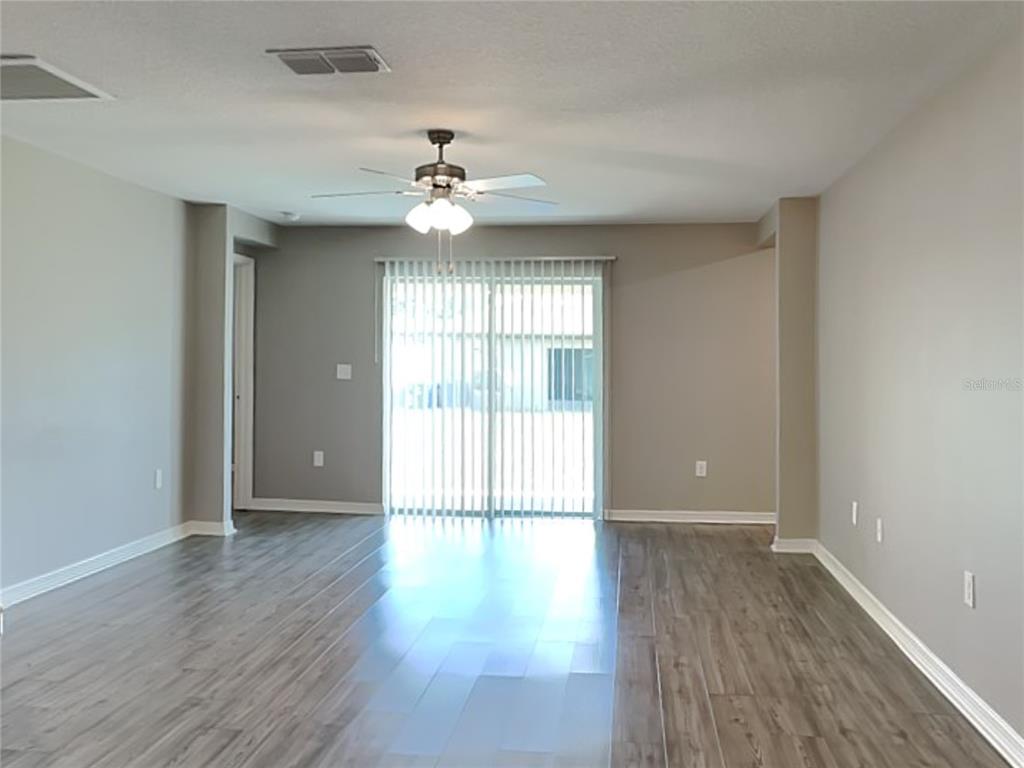 Undisclosed Address Lakeland, FL 33811 - Photo 3 of 17 wooden floor in an empty room with a window