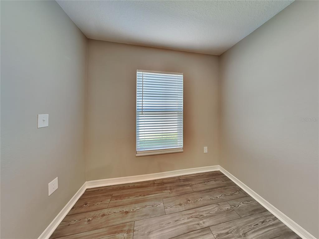 Undisclosed Address Lakeland, FL 33811 - Photo 6 of 17 a view of an empty room with wooden floor and a window