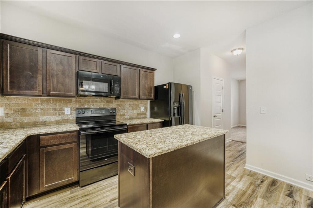 323 Bandelier Circle Hampton, GA 30228 - Photo 11 of 28 a kitchen with a refrigerator sink and microwave