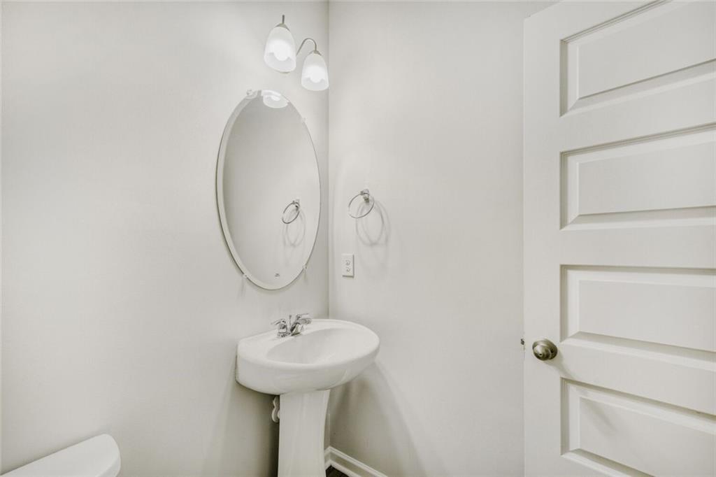 323 Bandelier Circle Hampton, GA 30228 - Photo 13 of 28 a bathroom with a sink and a mirror