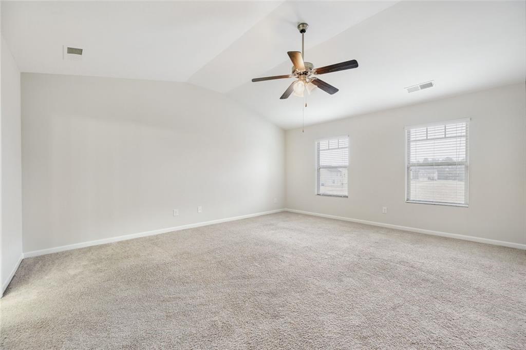 323 Bandelier Circle Hampton, GA 30228 - Photo 14 of 28 an empty room with windows and fan