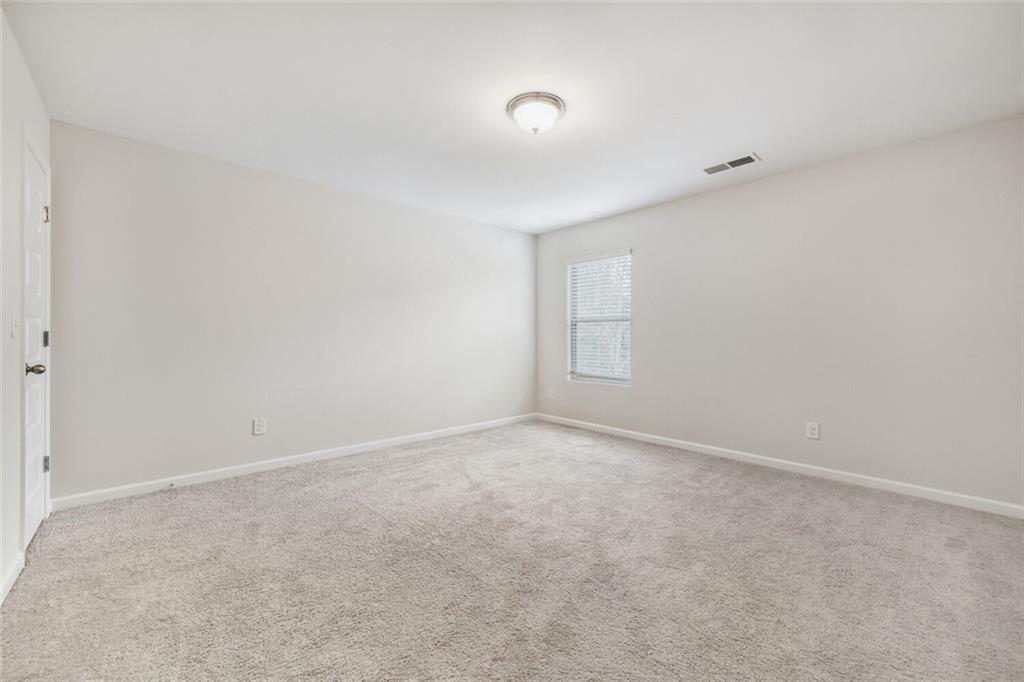 323 Bandelier Circle Hampton, GA 30228 - Photo 17 of 28 a view of an empty room and a window