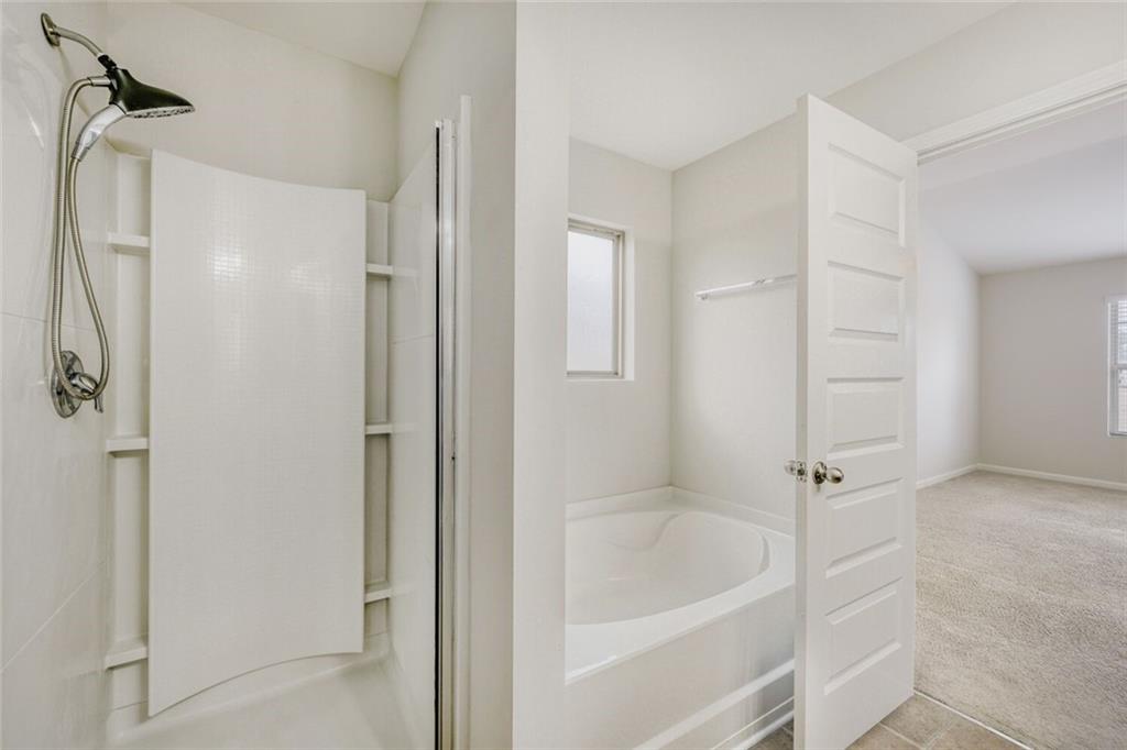 323 Bandelier Circle Hampton, GA 30228 - Photo 24 of 28 a white bath tub sitting next to a shower