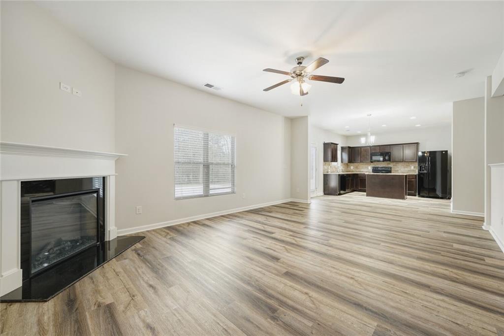 323 Bandelier Circle Hampton, GA 30228 - Photo 8 of 28 a view of an empty room with a fireplace and a window