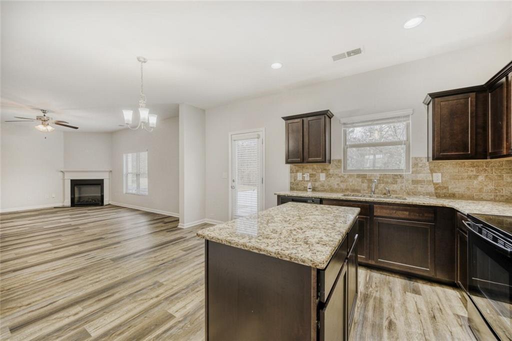 323 Bandelier Circle Hampton, GA 30228 - Photo 9 of 28 a kitchen with granite countertop sink stove and refrigerator